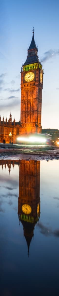 The Palace of Westminster clock tower reflected at dusk