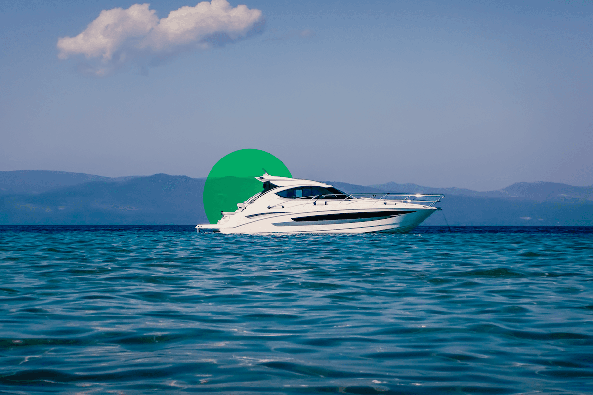White and gray Class A motorhome driving on desert highway surrounded by scrub brush and arid terrain