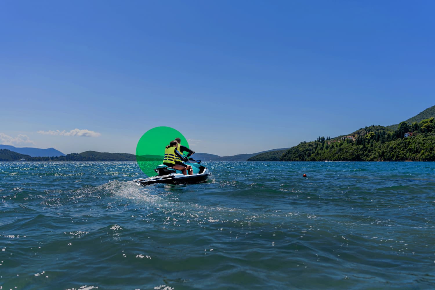 Layered mountain ranges with evergreen forest and clear blue sky, scenic mountain wilderness landscape