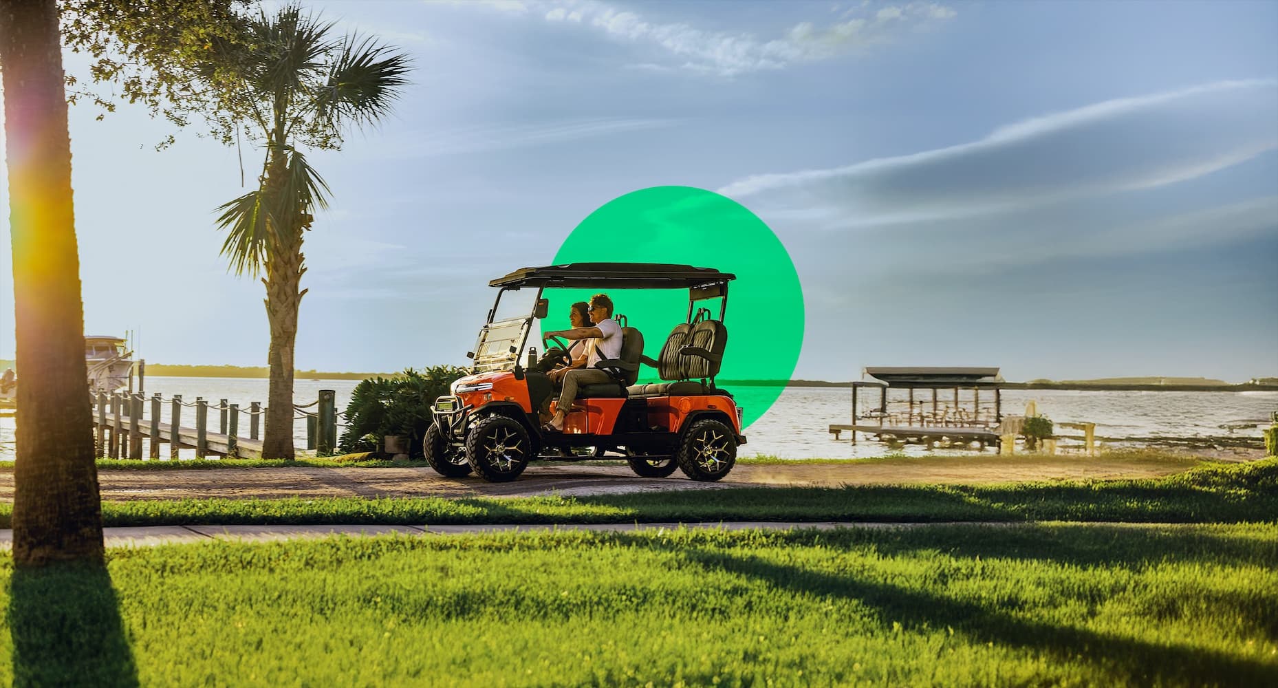 A couple riding on a gulf cart on a beach