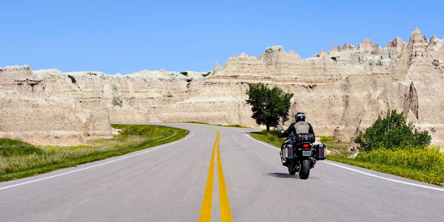 Motorcycle rider on a scenic road through South Dakota