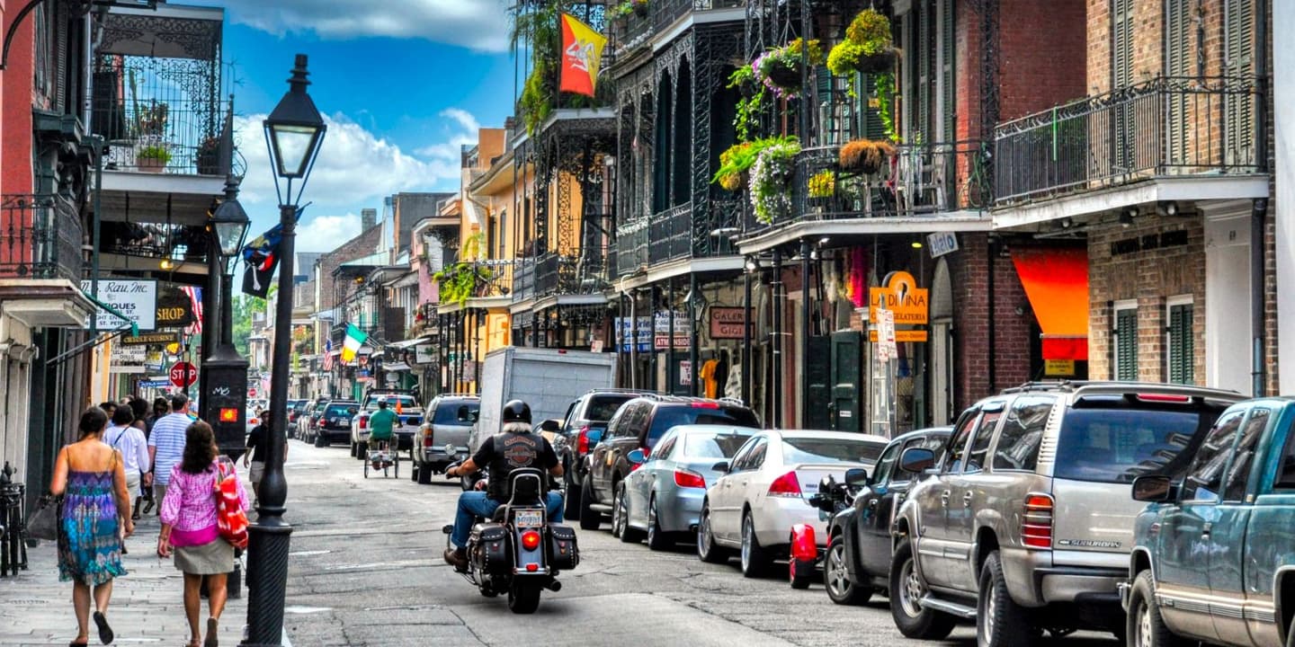 Motorcycle rider traveling through a historic street in Louisiana