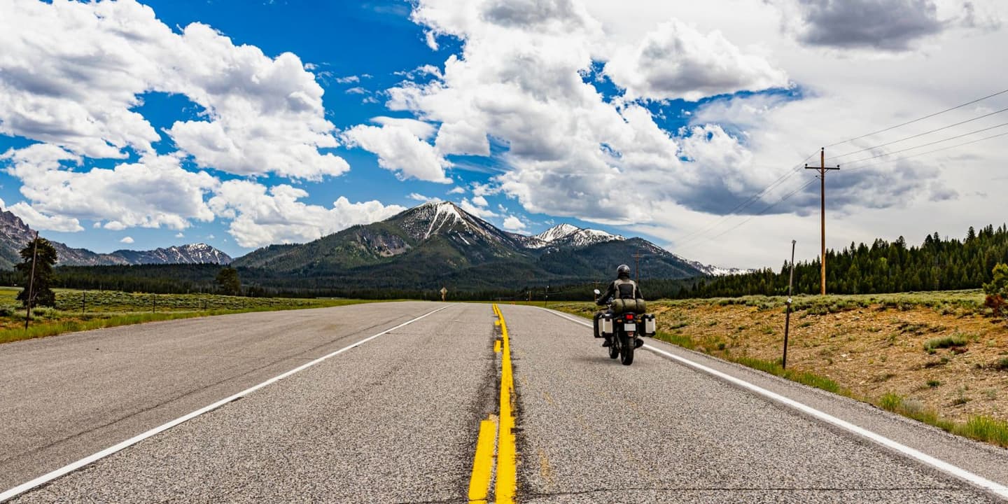 Motorcycle rider traveling along a scenic highway in Idaho