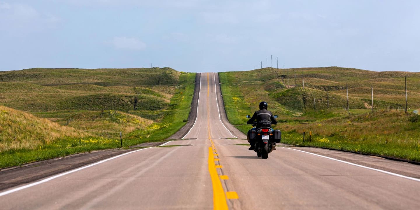 Motorcycle rider traveling along a scenic rural road in Nebraska.