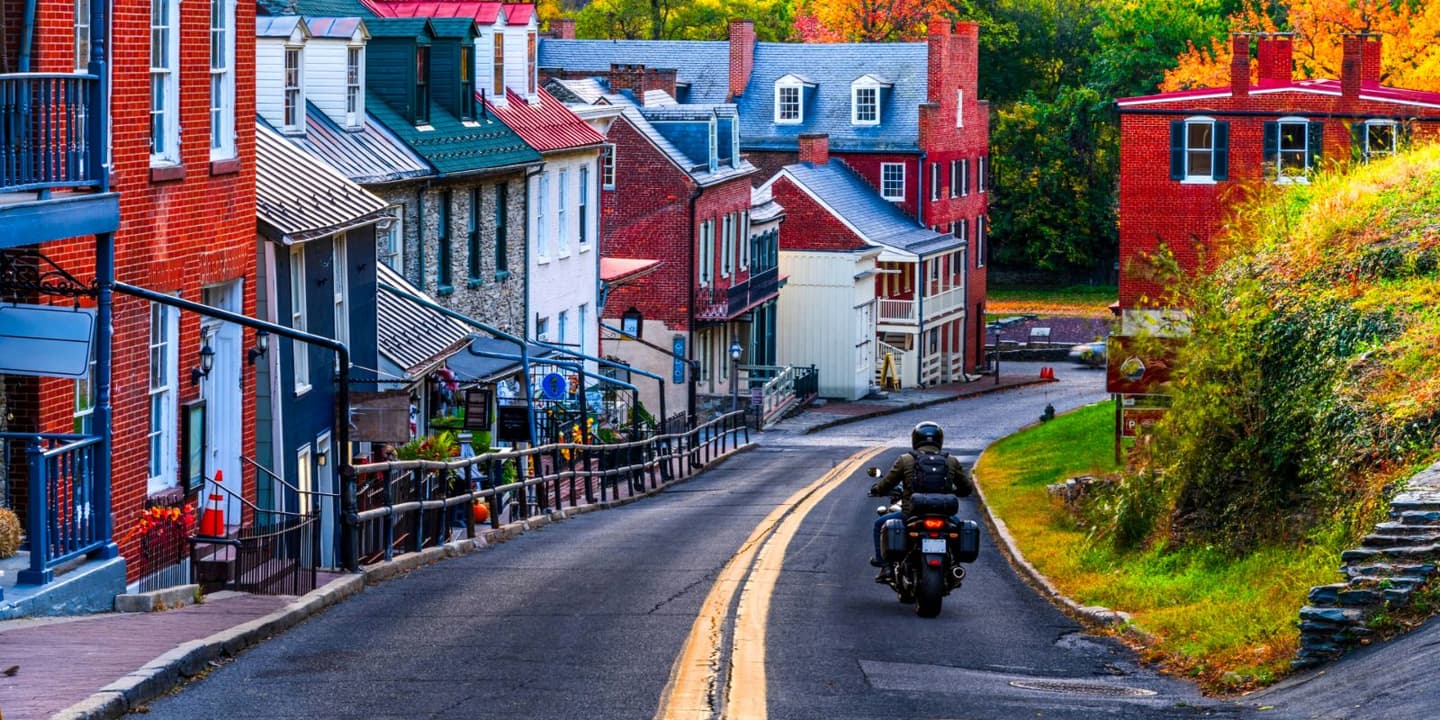 Motorcycle rider traveling through a town in West Virginia
