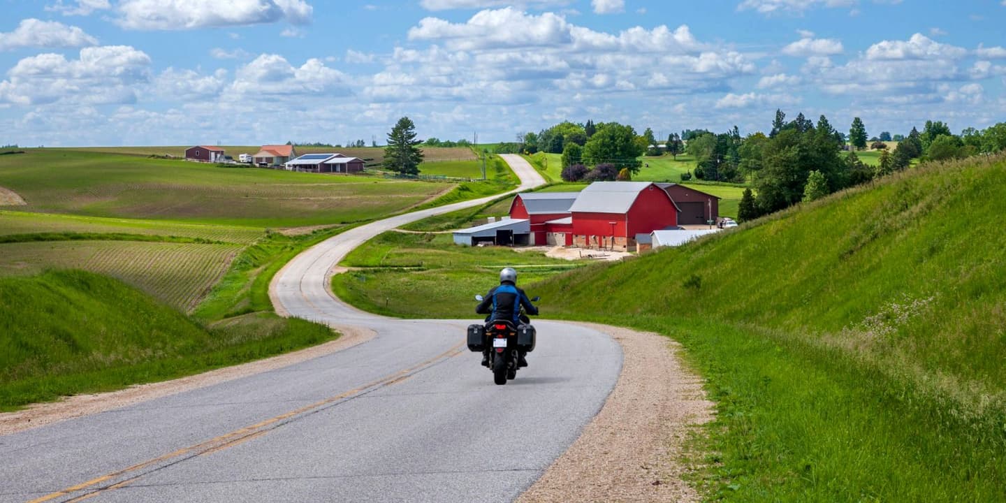 Motorcycle rider traveling along a rural road in Iowa