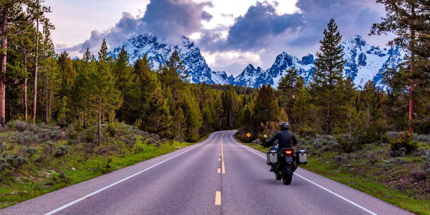 Motorcycle rider traveling on a scenic road through Wyoming