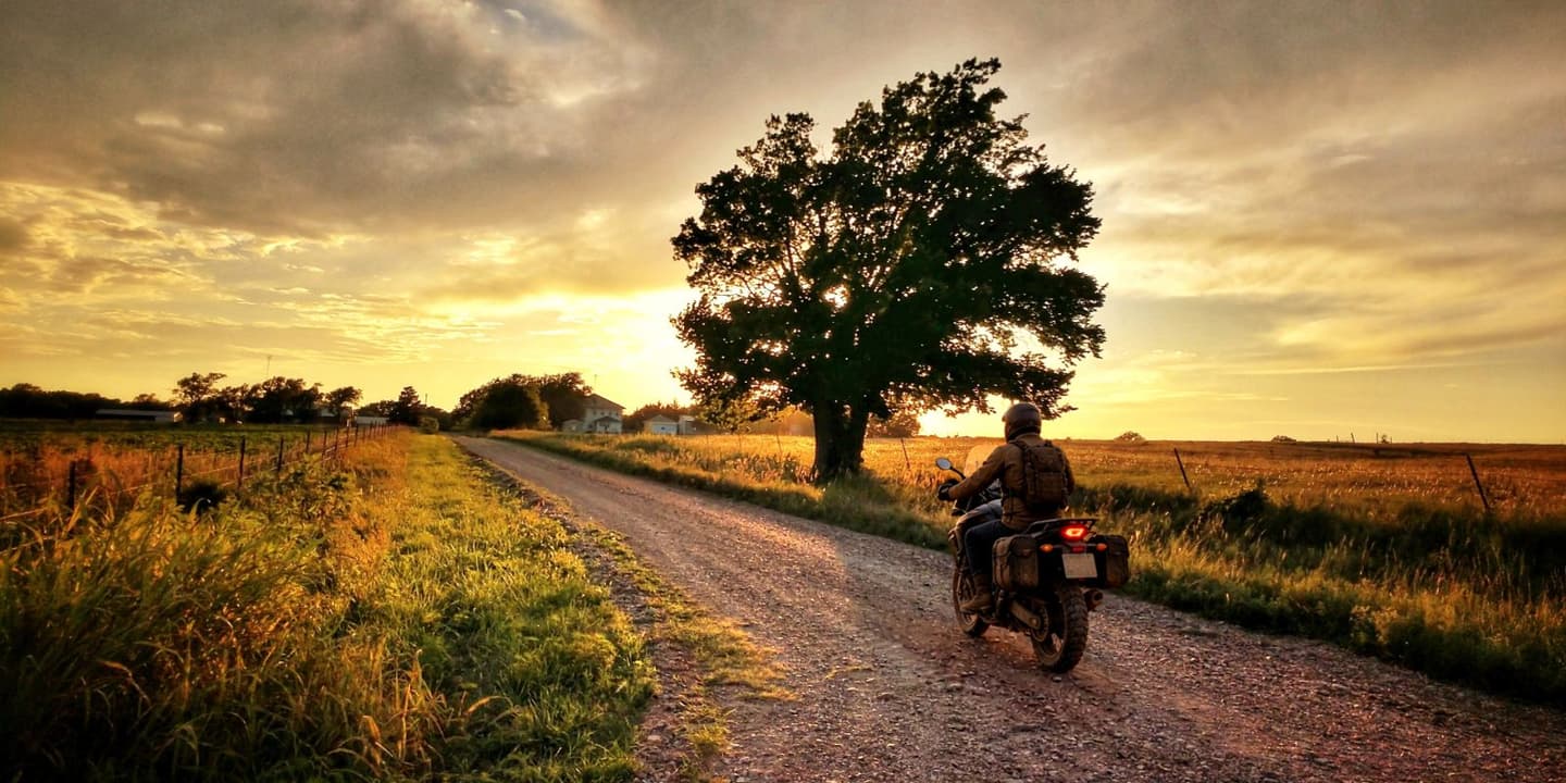 Motorcycle rider traveling on a scenic rural road in Kansas