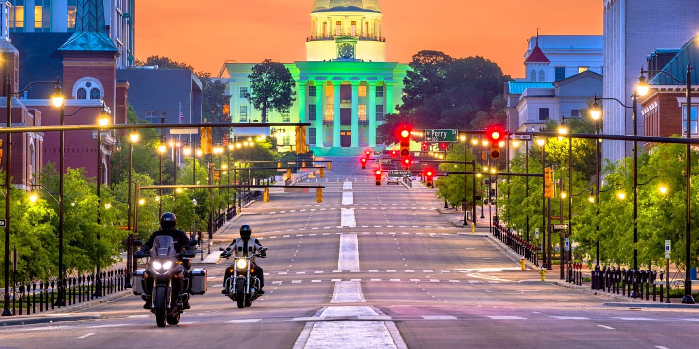 Motorcycle rider approaching a city landmark in Alabama