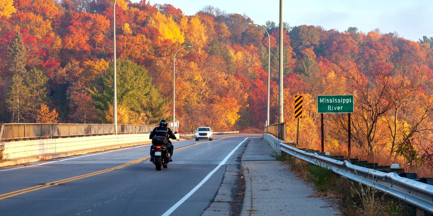 Motorcycle rider traveling through the fall scenery of Mississippi