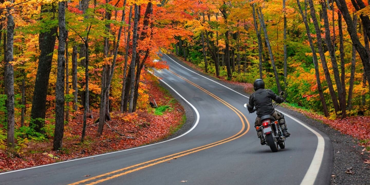 Motorcycle rider in Michigan riding an insured motorcycle on a scenic country road